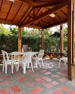 a patio with a table and chairs under a pavilion at finca de recreo in Sopetran