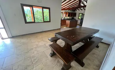 a dining room with a wooden table and benches at Chalets Villa Marina in Copacabana