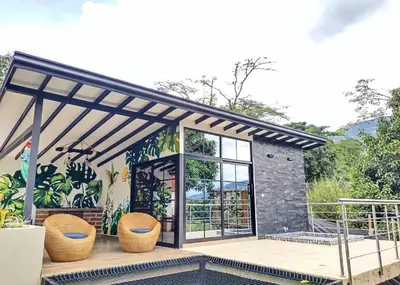 a patio with two wicker chairs and a pergola at Chalets Villa Marina in Copacabana