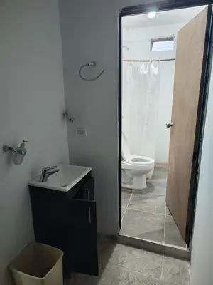 a bathroom with a toilet and a sink and a mirror at Spacious and calm place to stay in Santa Fe de Antioquia