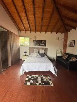 a bedroom with a bed and a checkered floor at Finca Villa Palmeras en Rionegro Aeropuerto JMC in Rionegro