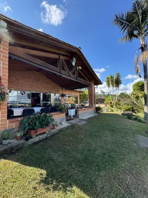 a house with a patio with plants in a yard at Finca Villa Palmeras en Rionegro Aeropuerto JMC in Rionegro