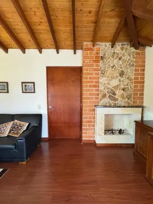 a living room with a couch and a fireplace at Finca Villa Palmeras en Rionegro Aeropuerto JMC in Rionegro