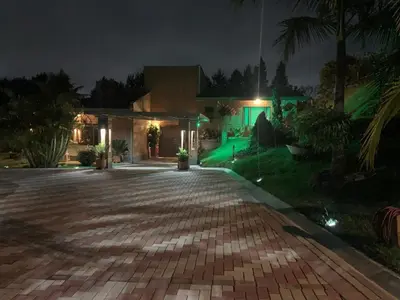 a driveway in front of a house at night at Finca Villa Palmeras en Rionegro Aeropuerto JMC in Rionegro