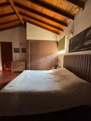 a bedroom with a large bed with a wooden ceiling at Finca Villa Palmeras en Rionegro Aeropuerto JMC in Rionegro