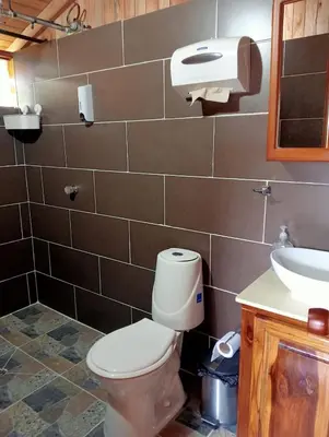 a bathroom with a toilet and a sink at Cabaña octaluz in Jardin
