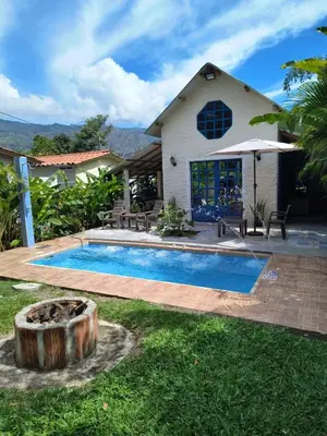 a swimming pool in front of a house at Cabaña G203 in Girardota
