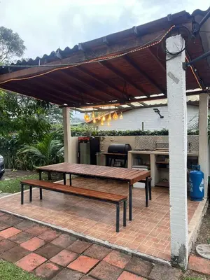 a picnic table and bench under a patio umbrella at Cabaña G203 in Girardota