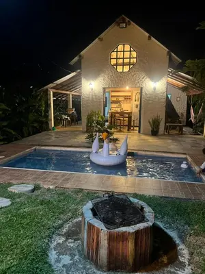 a house with a backyard with a pool and an inflatablelatable boat at Cabaña G203 in Girardota