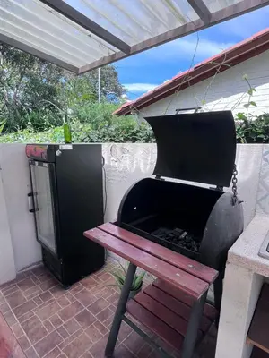 a barbecue grill and a picnic table on a patio at Cabaña G203 in Girardota