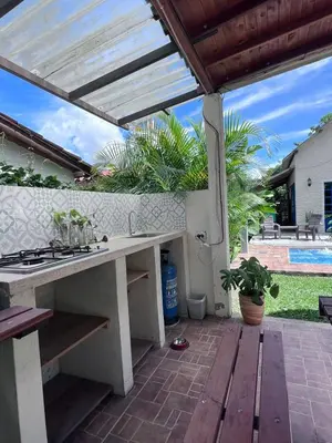 an outdoor kitchen with a table and a stove at Cabaña G203 in Girardota