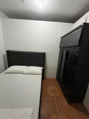 a bedroom with a bed and a black dresser at Apartamento Amoblado en Doradal in Las Mercedes
