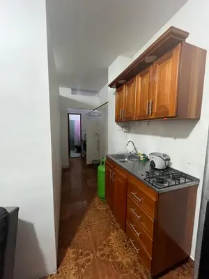 a kitchen with a stove and a sink and a hallway at Apartamento Amoblado en Doradal in Las Mercedes