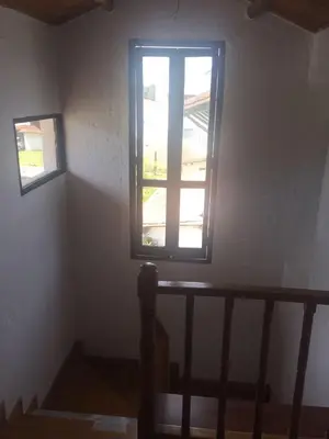 a staircase with a window in a room at Espectacular Casa frente al campo de Golf in Rionegro