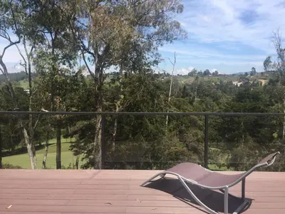 a chair sitting on top of a patio at Espectacular Casa frente al campo de Golf in Rionegro
