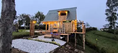 a tree house with lights on the outside of it at Marinilla - Cabañas Perlas Black - in Marinilla