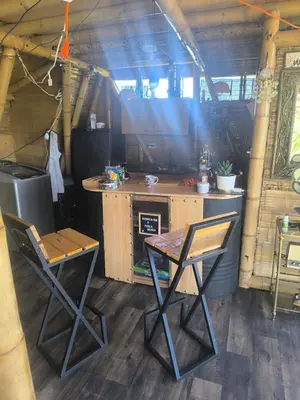 a kitchen with two chairs and a table and a stove at Marinilla - Cabañas Perlas Black - in Marinilla