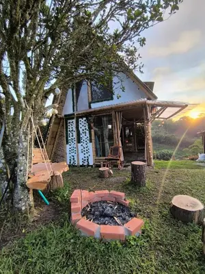 a house with a fire pit in front of it at Marinilla - Cabañas Perlas Black - in Marinilla