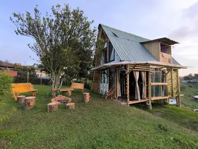 a log cabin with a table and benches in front of it at Marinilla - Cabañas Perlas Black - in Marinilla