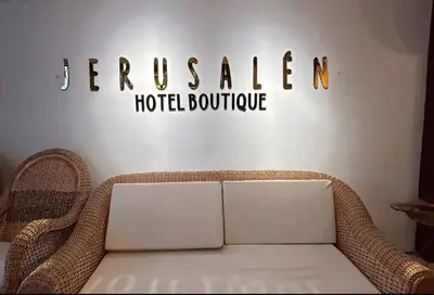a sign for a hotel room with a wicker chair at Jerusalén Hotel Boutique in Mariquita