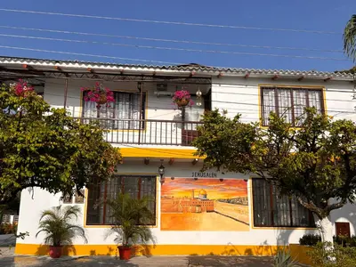 a building with a mural on the side of it at Jerusalén Hotel Boutique in Mariquita
