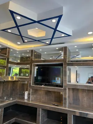 a lobby with a flat screen tv and a ceiling at Jerusalén Hotel Boutique in Mariquita