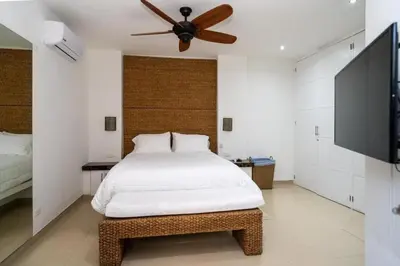 a bedroom with a bed and a ceiling fan at Jerusalén Hotel Boutique in Mariquita
