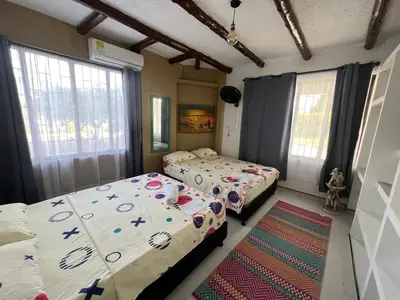 a bedroom with two beds and a rug at Jerusalén Hotel Boutique in Mariquita