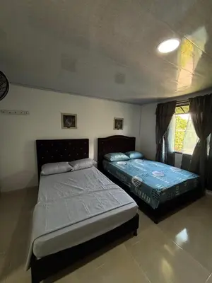 a bedroom with two beds in a room at Habitación la esmeralda in Puerto Triunfo