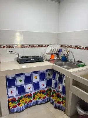 a kitchen with a sink and a counter with towels at Habitación la esmeralda in Puerto Triunfo