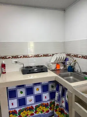 a kitchen counter with a sink and a stove at Habitación la esmeralda in Puerto Triunfo