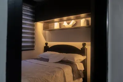 a bedroom with a bed with two pillows at Apartamento en Rionegro in Rionegro