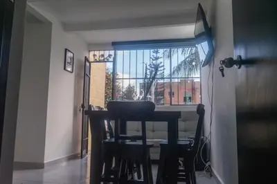 a dining room with a table and chairs and a window at Apartamento en Rionegro in Rionegro