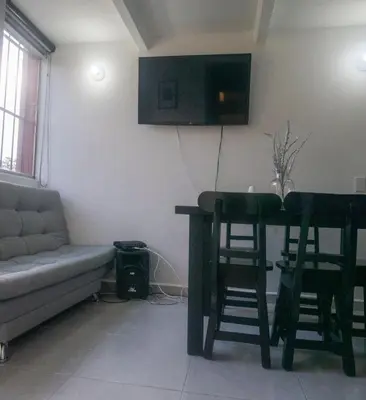 a living room with a table and chairs and a couch at Apartamento en Rionegro in Rionegro