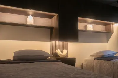 a bedroom with two beds and shelves with towels at Apartamento en Rionegro in Rionegro