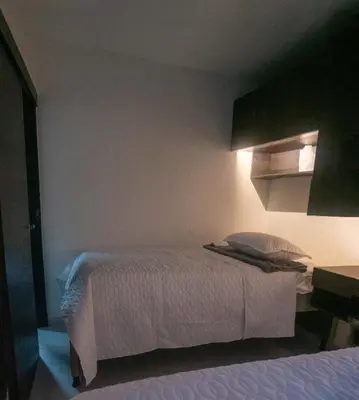 a bedroom with a bed with a white bedspread at Apartamento en Rionegro in Rionegro