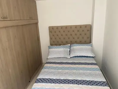 a small bedroom with a bed and a closet at Magnífico apto para disfrutar su estadia in Medellín
