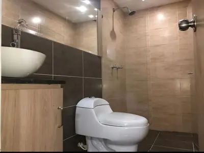 a bathroom with a white toilet and a sink at Magnífico apto para disfrutar su estadia in Medellín