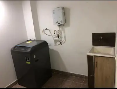 a bathroom with a water heater and a sink at Magnífico apto para disfrutar su estadia in Medellín
