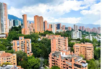 a view of a city with tall buildings and trees at Apartaestudio en el poblado cerca a Povenza 241 in Medellín