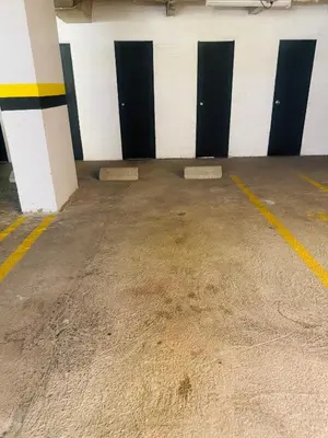 an empty garage with black and white doors at Apartaestudio en el poblado cerca a Povenza 241 in Medellín