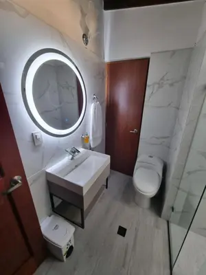 a bathroom with a sink and a toilet and a mirror at Hermoso Apartamento Poblado - Manila in Medellín