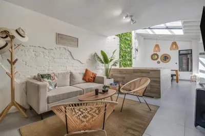 a living room with a couch and a table at MAKONDO - Large Jacuzzi and AC on Main Provenza St in Medellín