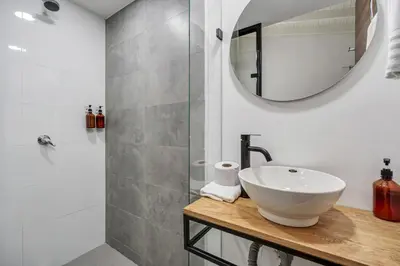 a bathroom with a sink and a mirror at MAKONDO - Large Jacuzzi and AC on Main Provenza St in Medellín