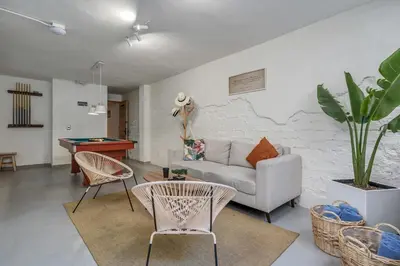 a living room with a couch and a table at MAKONDO - Large Jacuzzi and AC on Main Provenza St in Medellín
