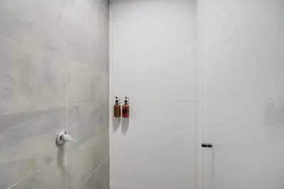 a shower in a bathroom with a glass door at MAKONDO - Large Jacuzzi and AC on Main Provenza St in Medellín
