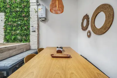 a wooden table in a room with a mirror at MAKONDO - Large Jacuzzi and AC on Main Provenza St in Medellín