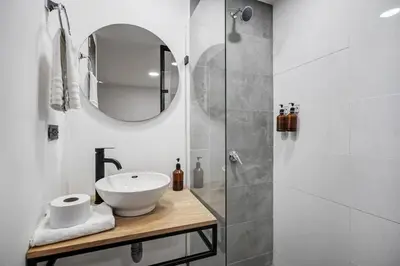 a bathroom with a sink and a shower at MAKONDO - Large Jacuzzi and AC on Main Provenza St in Medellín