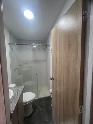 a bathroom with a toilet and a glass shower at Apto - Vista Única en Manizales in Manizales