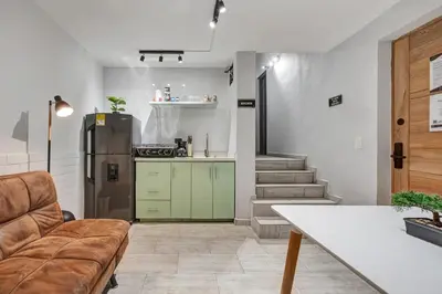a kitchen with a couch and a refrigerator in a room at GAIRA - Provenza Walkable Area, AC & Balcony facing KarolG club in Medellín